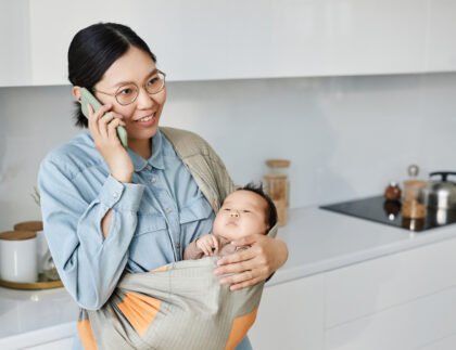 mom with baby having conversation on mobile phone 2023 11 27 05 30 51 utc