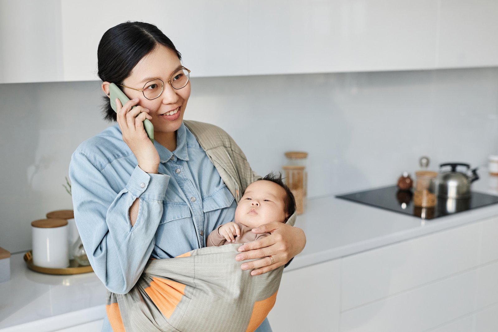 mom with baby having conversation on mobile phone 2023 11 27 05 30 51 utc