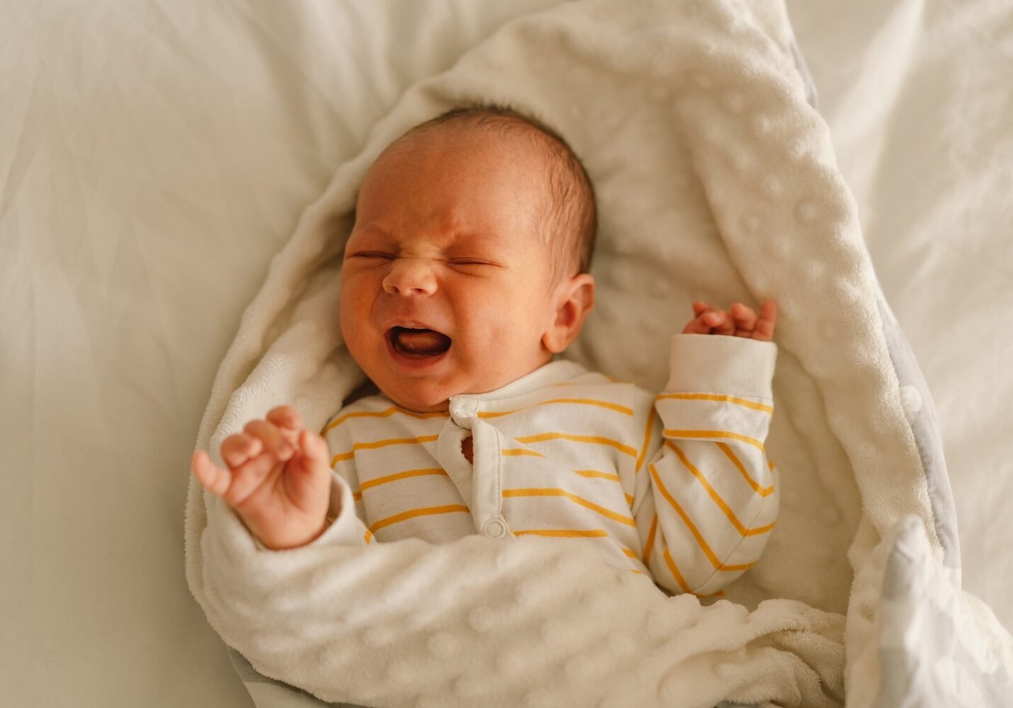 cute-emotional-newborn-little-baby-boy-cry-in-crib-2023-11-27-05-27-05-utc